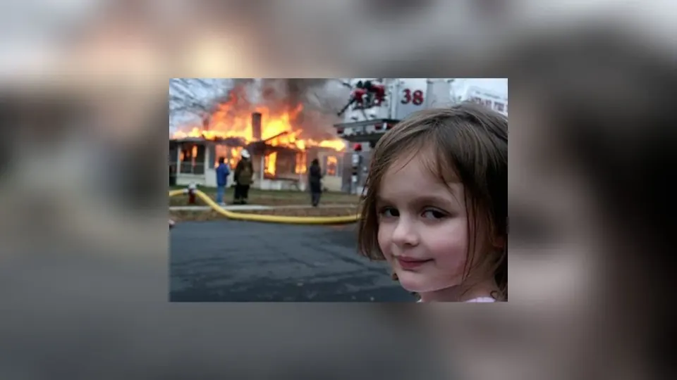 The Disaster Girl photograph: a small girl smiling at the camera while a house burns behind her