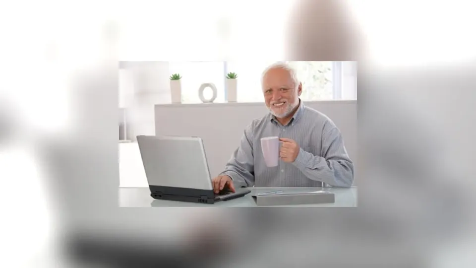 András Arató in the stock photograph known as Hide the Pain Harold, smiling with visibly unhappy eyes